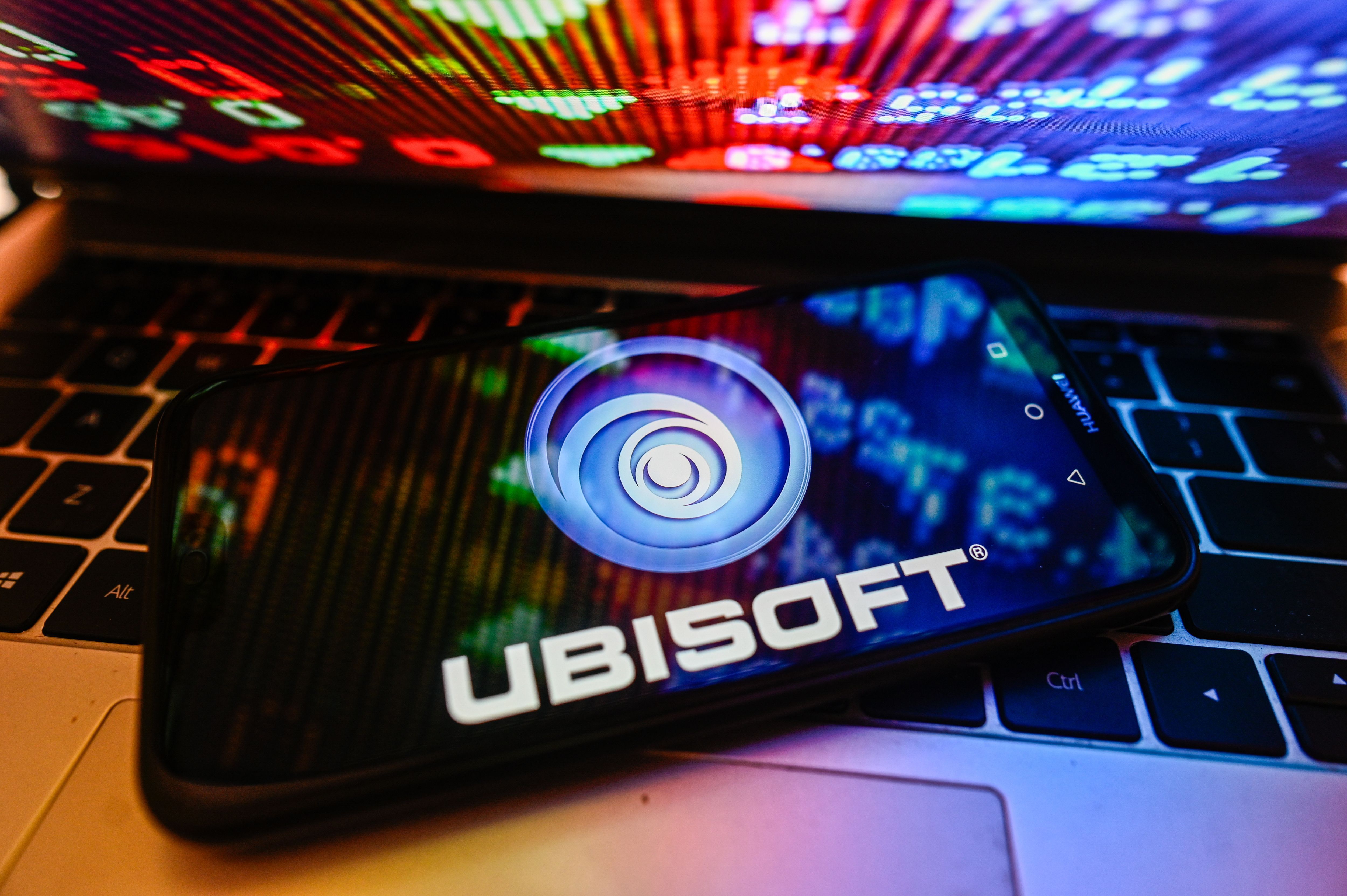 In this photo illustration a UbiSoft logo is displayed on a