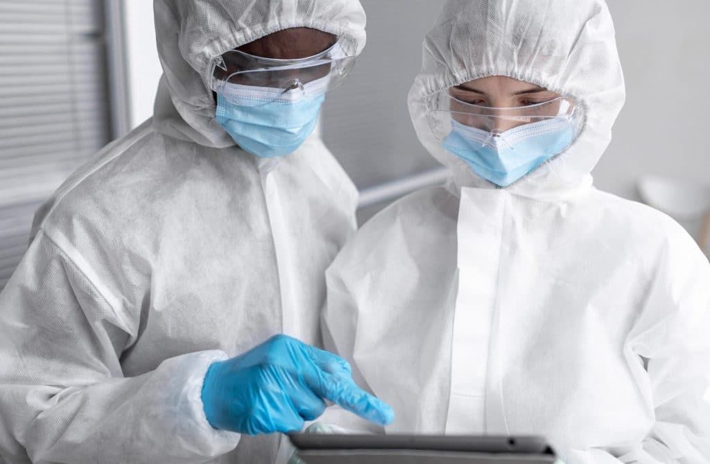 people-wearing-protective-suit-biohazard-area-scaled-e1779392325379-1024x669