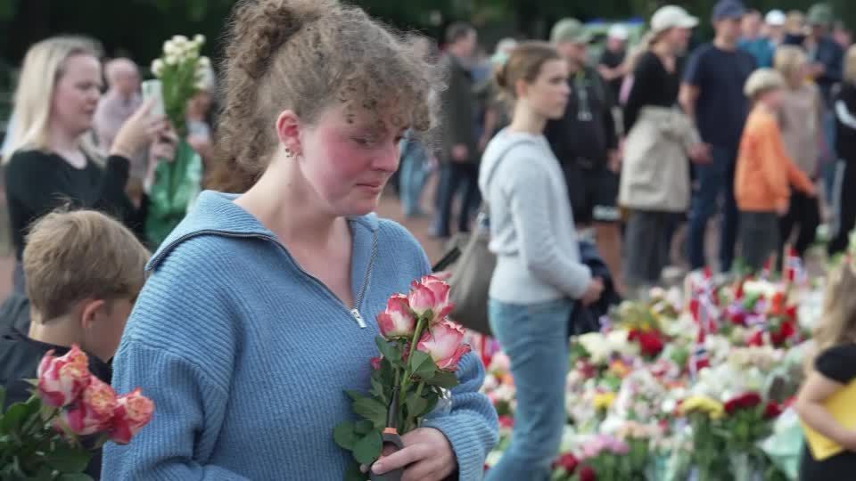 Noruegueses emocionados depositam flores em frente ao palácio real após a morte do rei.