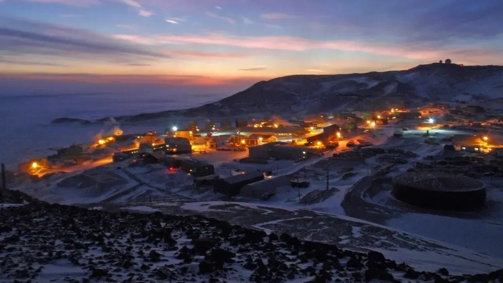 A Estação McMurdo iluminada durante o amanhecer